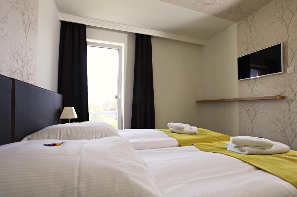 Postel nebo postele na pokoji v ubytování Hotel Warnow