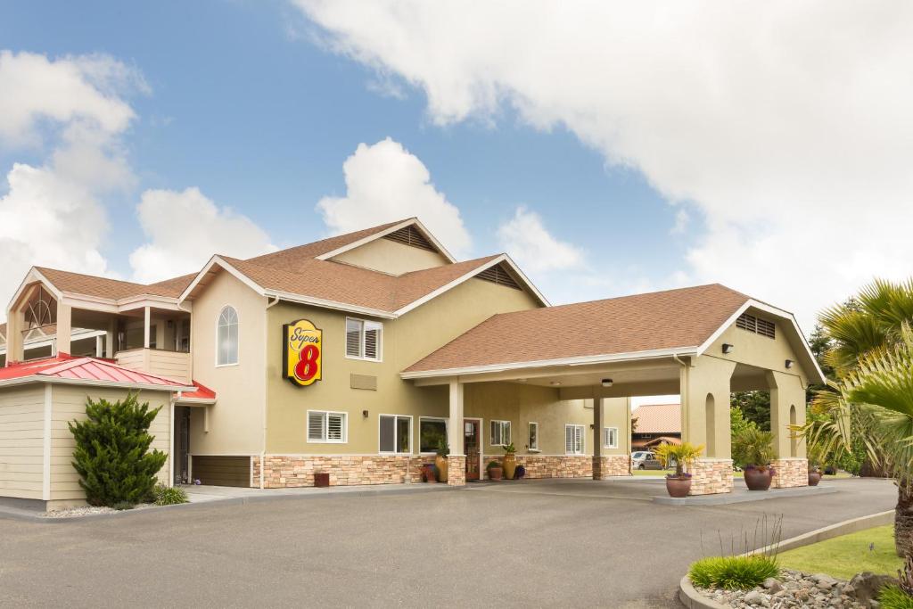 a large house with a driveway in front of it at Super 8 by Wyndham Fortuna in Fortuna
