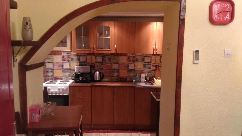 a kitchen with wooden cabinets and a stove top oven at Apartment Luka in Podgorica