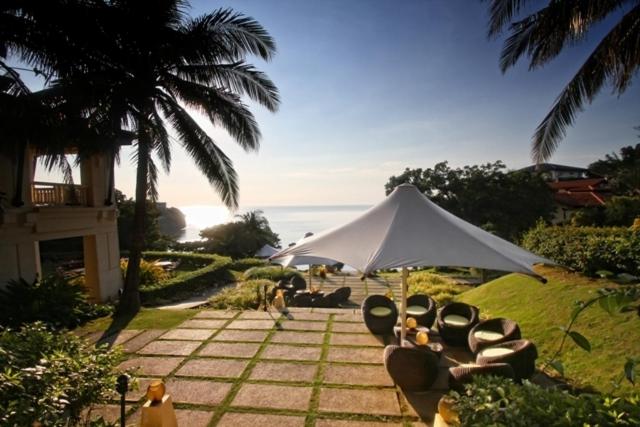 a group of chairs under a white umbrella at Club Punta Fuego in Nasugbu