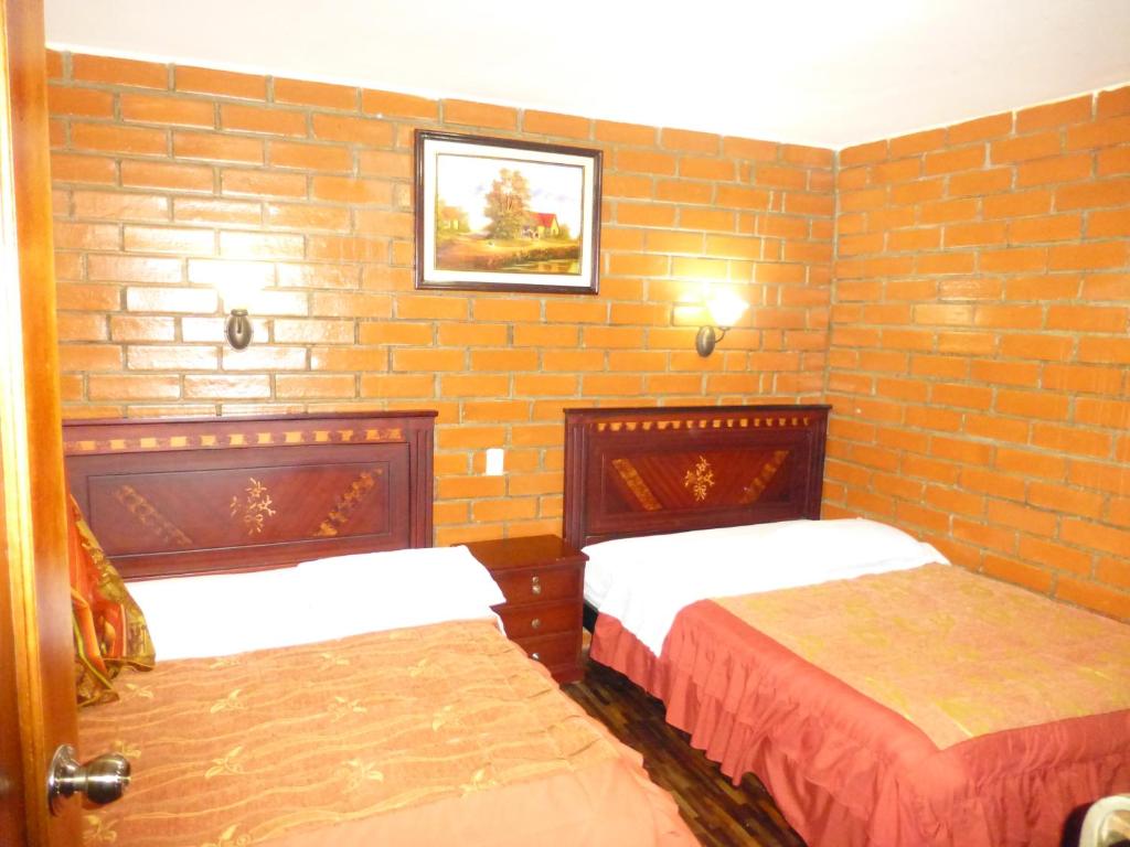 Postel nebo postele na pokoji v ubytování Hostal Nomada