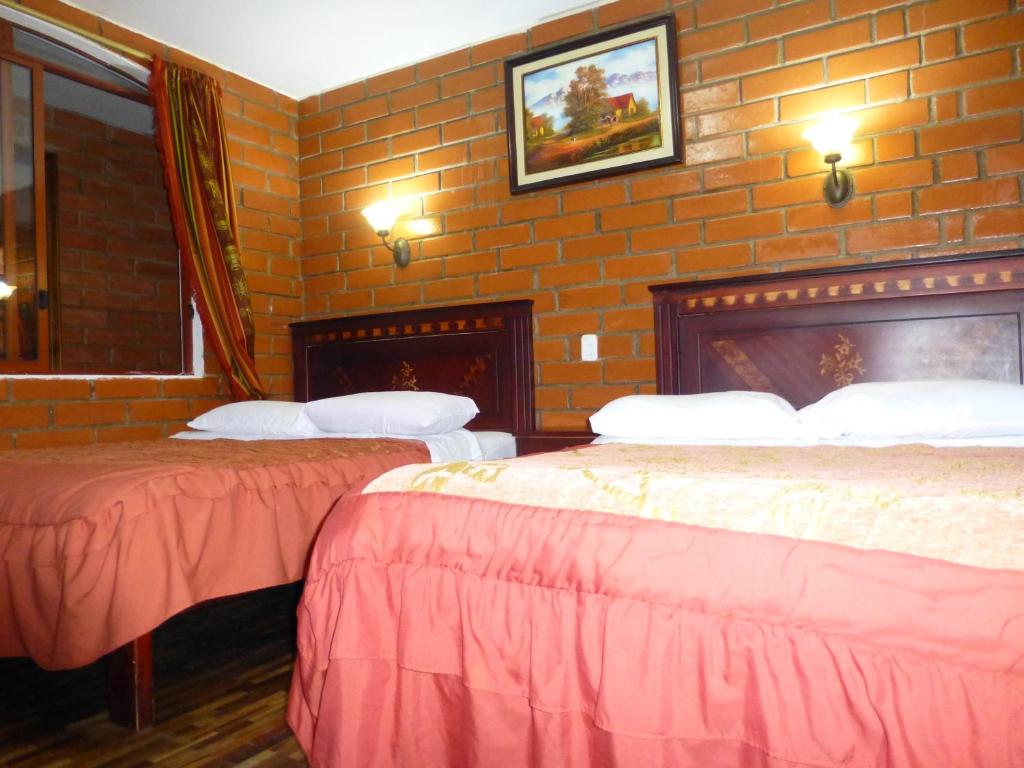 Postel nebo postele na pokoji v ubytování Hostal Nomada