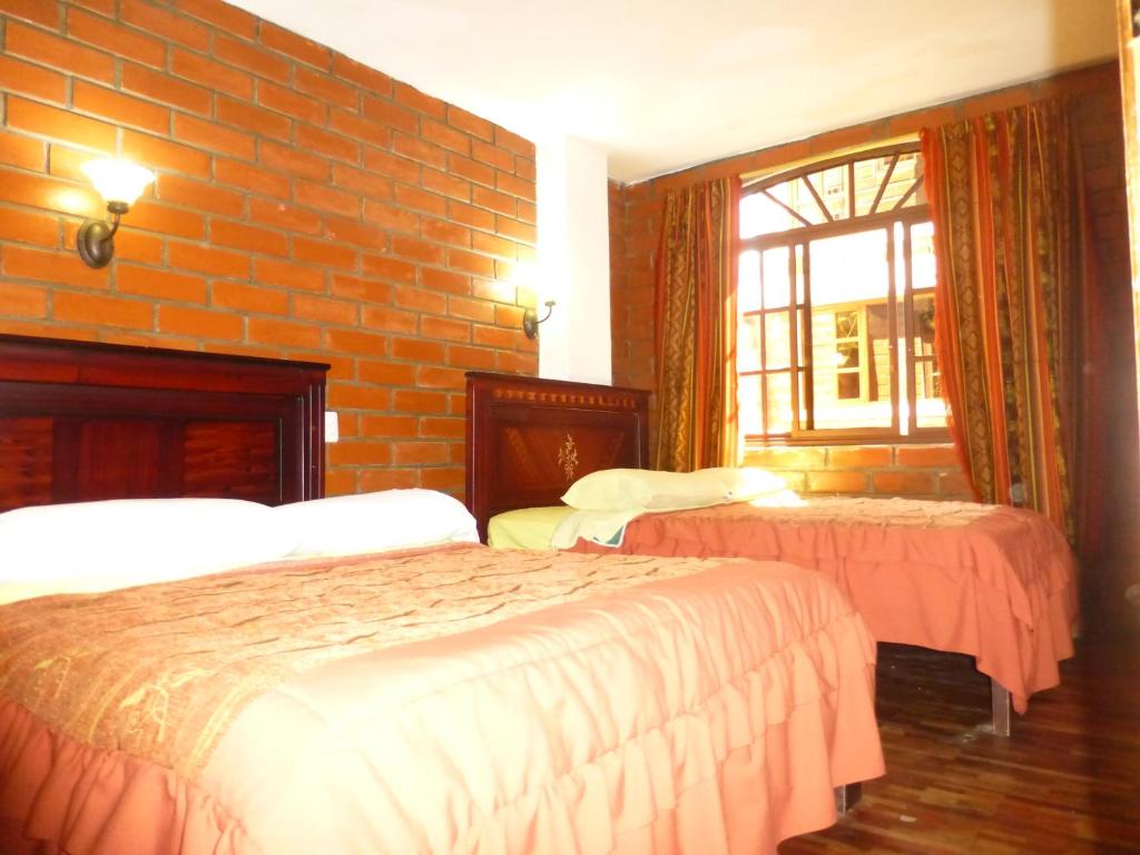 Postel nebo postele na pokoji v ubytování Hostal Nomada