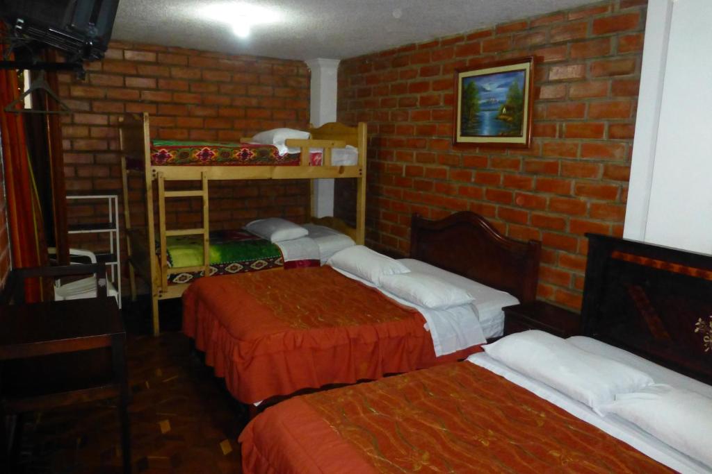 Postel nebo postele na pokoji v ubytování Hostal Nomada