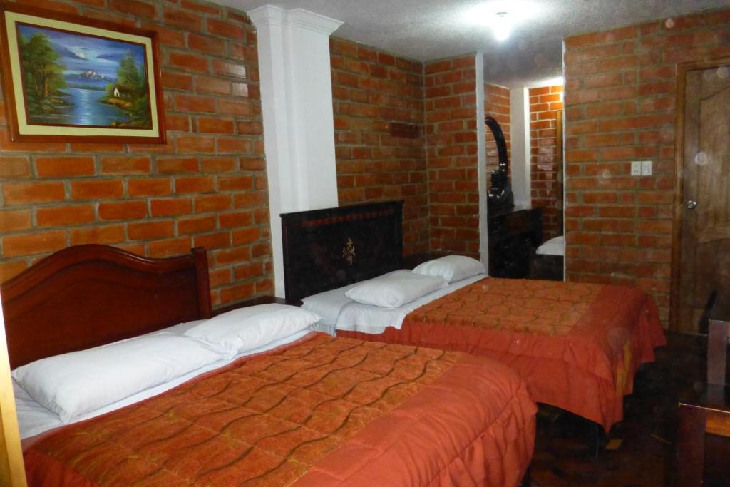 Postel nebo postele na pokoji v ubytování Hostal Nomada