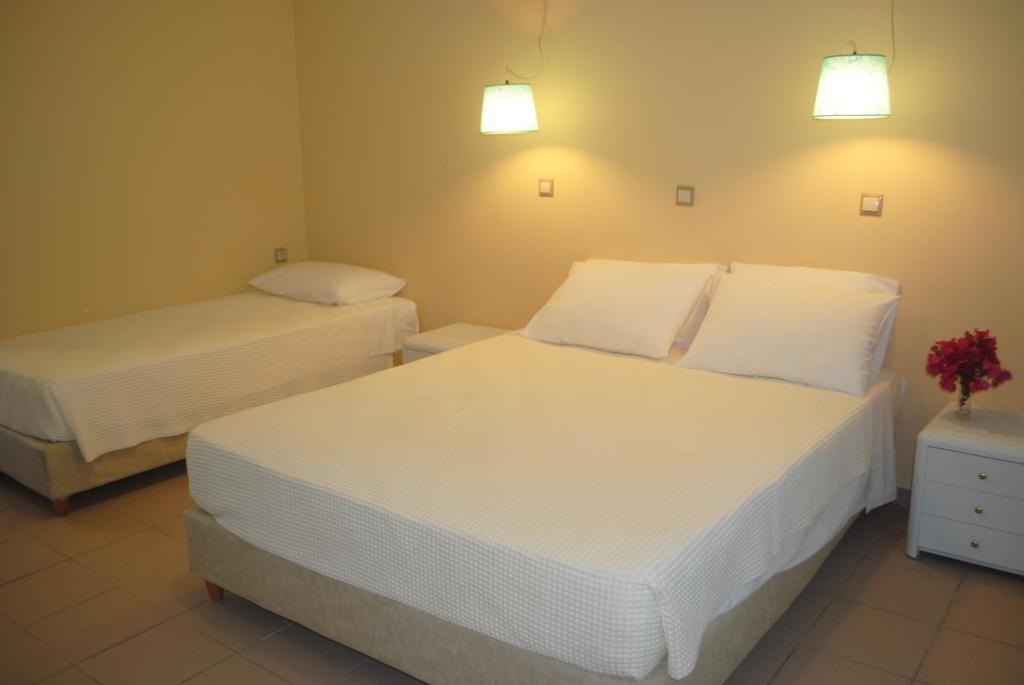 Postel nebo postele na pokoji v ubytování Apollonia Hotel
