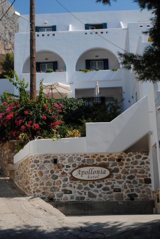 a white building with stairs and flowers in front of it at Apollonia Hotel in Masouri
