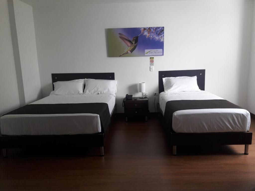 Postel nebo postele na pokoji v ubytování Hotel Valle de San Nicolas