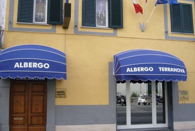 a building with blue awnings on the side of it at Hotel Terranova in Pisa
