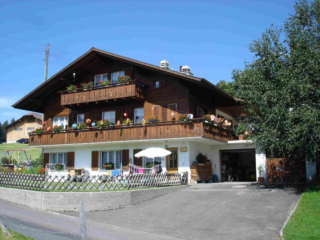 a large house with a balcony on top of it at Chalet Sunneschyn in Schwanden
