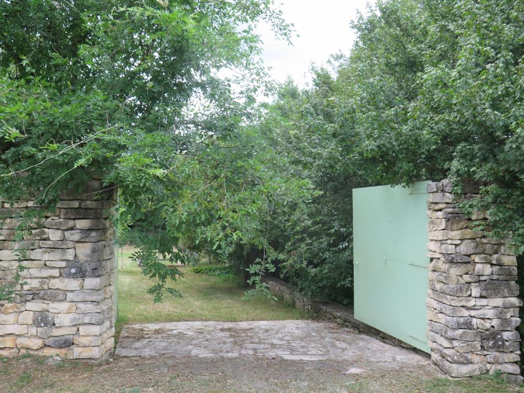 an entrance to a stone wall with a green door at Holiday Home Augusta in Žminj