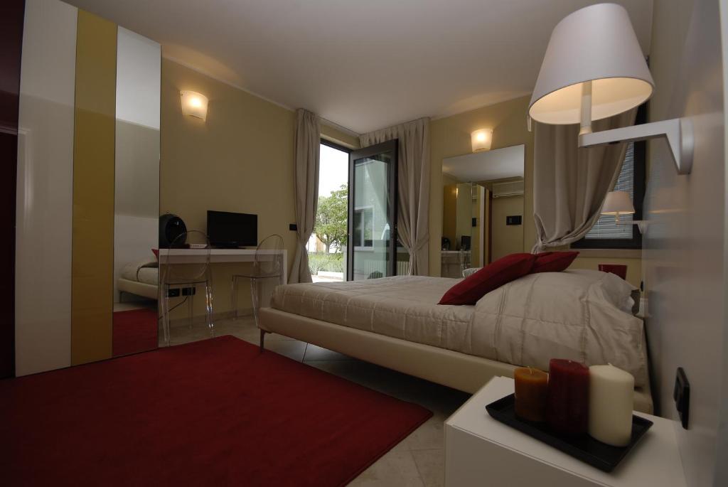 a bedroom with a large bed and a desk with a computer at Relais Corte Bergamini in Peschiera del Garda