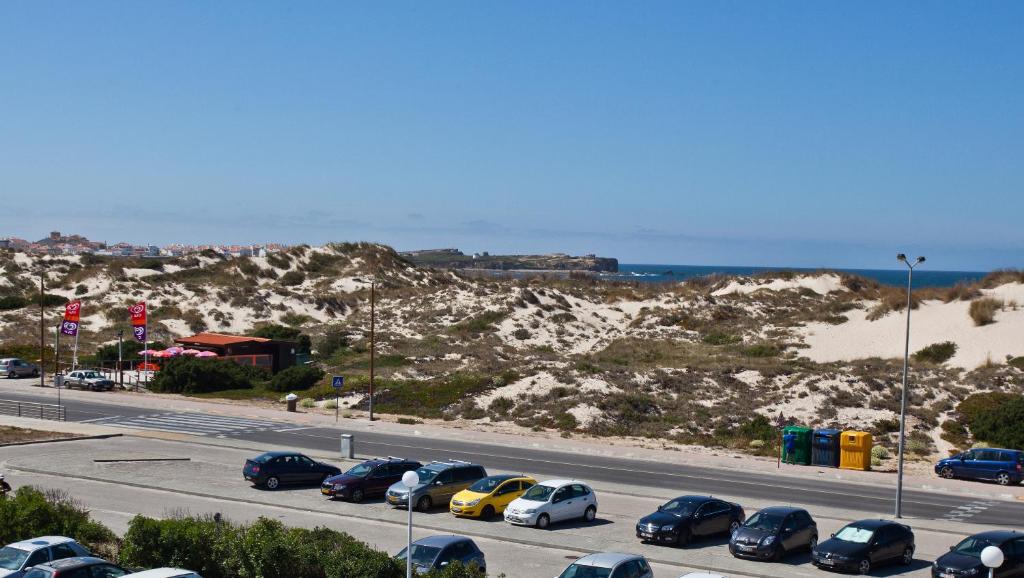 a parking lot with cars parked on the side of a highway at Star inn Peniche in Peniche