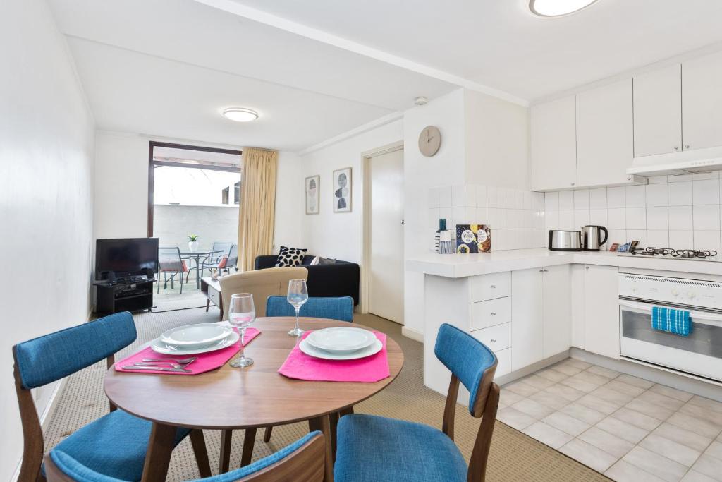 a kitchen and dining room with a table and chairs at South Perth Executive Apartment in Perth