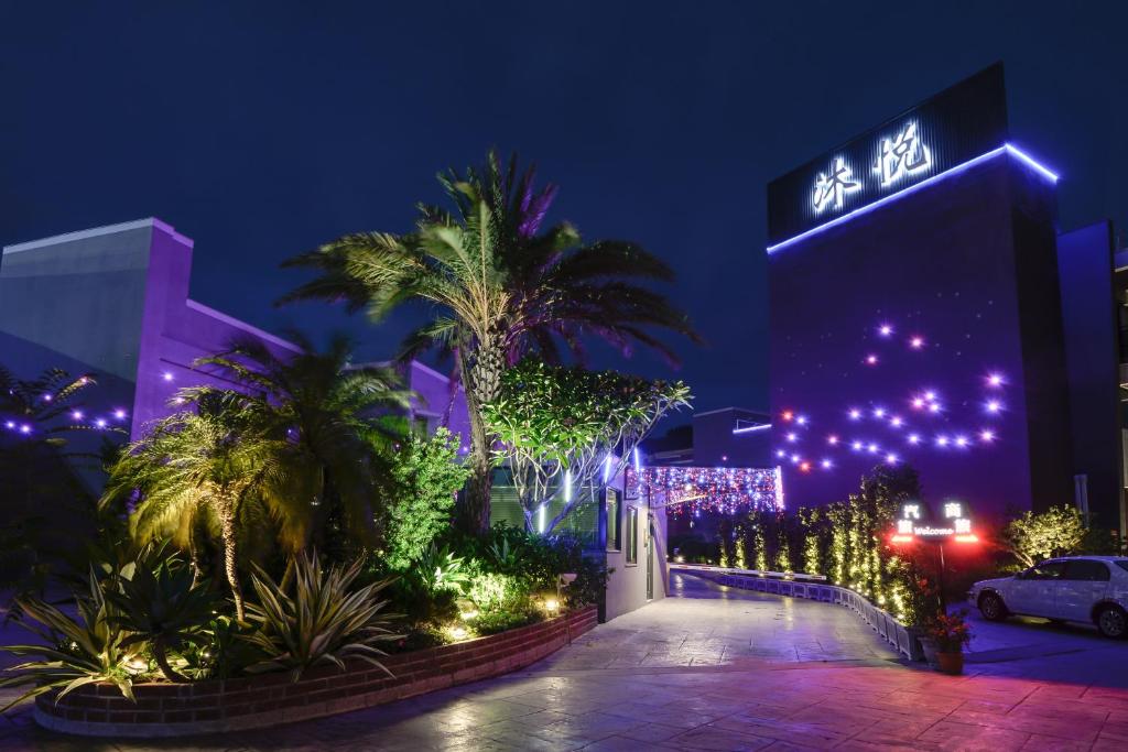 a night view of a building with christmas lights at M Hotel in Caotun