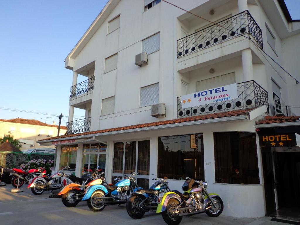 a row of motorcycles parked in front of a hotel at Hotel 4 Estacoes in Chaves