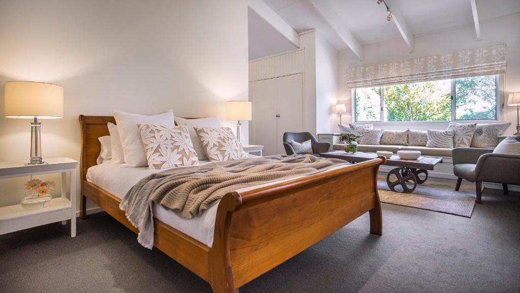 a bedroom with a large bed and a living room at The Reserve Barossa Valley in Nuriootpa