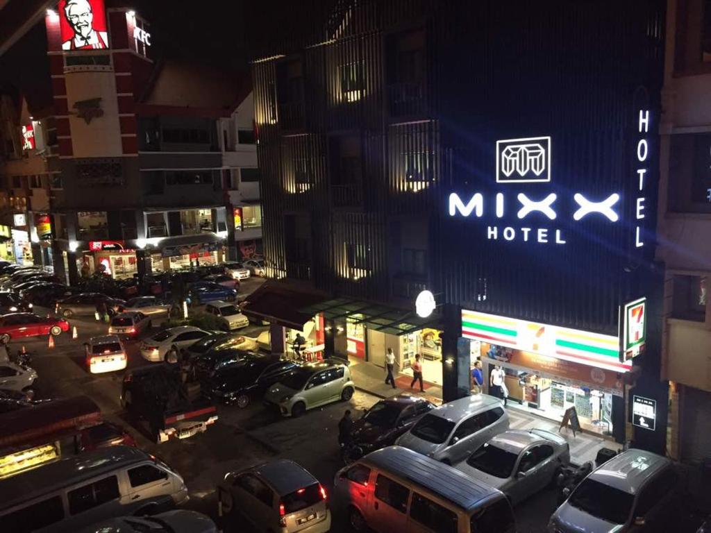 a busy city street with cars parked in front of a hotel at Mixx Ekpress Sunway in Petaling Jaya