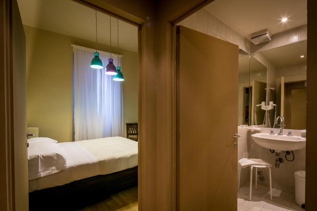 1 dormitorio con cama, lavabo y espejo en Bed and Breakfast Mameli 67, en Montefalco