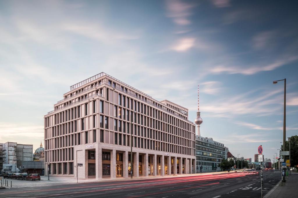 a large white building on a city street with a street at Capri by Fraser Berlin in Berlin