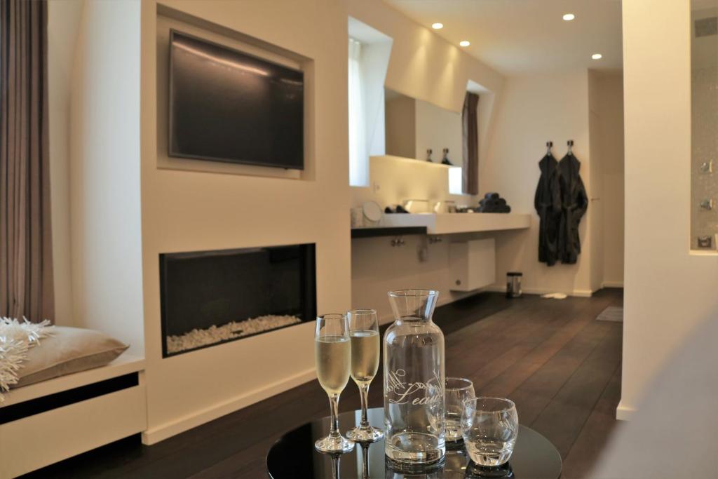 a dining room with wine glasses on a table at B&B For 2-Wellness For 2 in Bruges