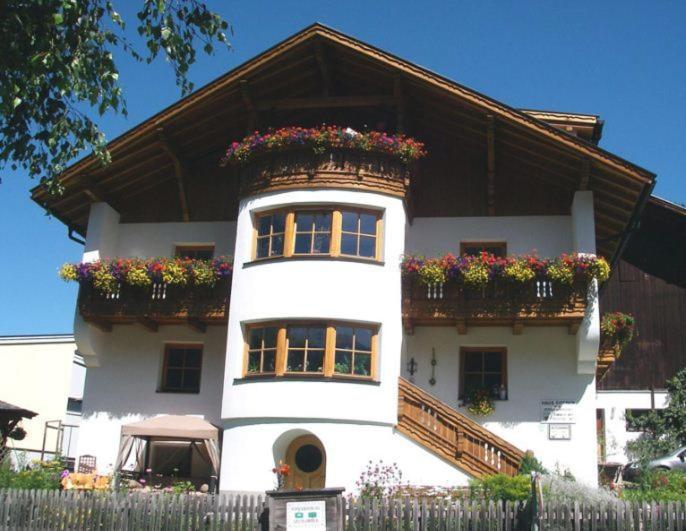 a large white house with flower boxes on it at Apartment Schullehrer in Kauns