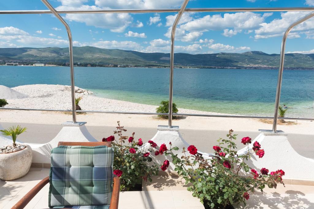 a view of the beach from a room with flowers at Apartment Marin in Trogir
