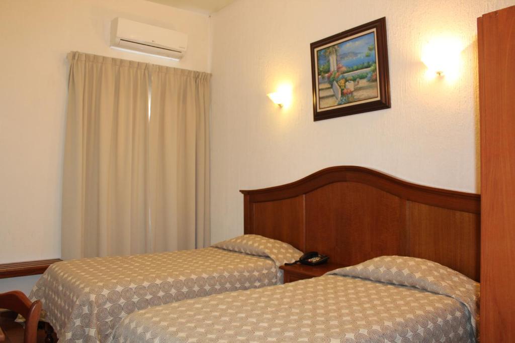 Postel nebo postele na pokoji v ubytování Hotel Posada Doña Lala