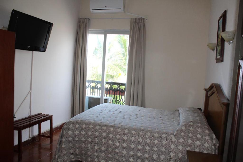 Postel nebo postele na pokoji v ubytování Hotel Posada Doña Lala