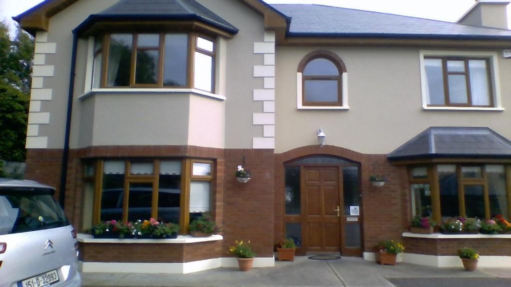 a large white house with a door and windows at Ard na Coille in Tralee