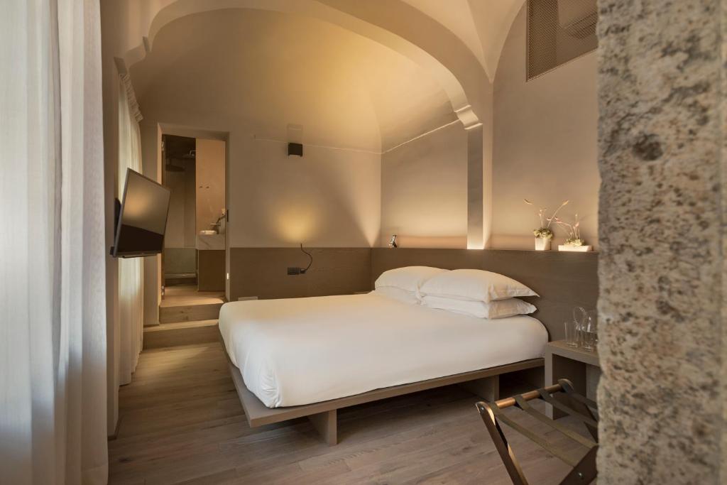 Postel nebo postele na pokoji v ubytování Hotel dei Barbieri