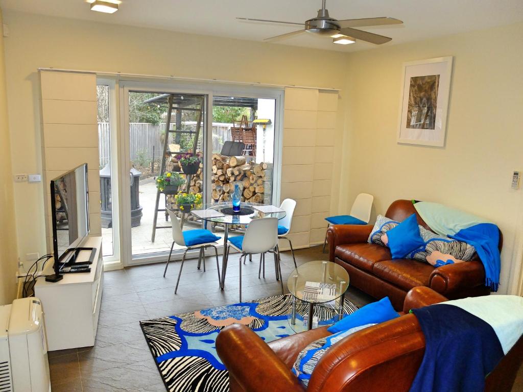 a living room with a couch and a table at Rock Wallaby in Kingston 