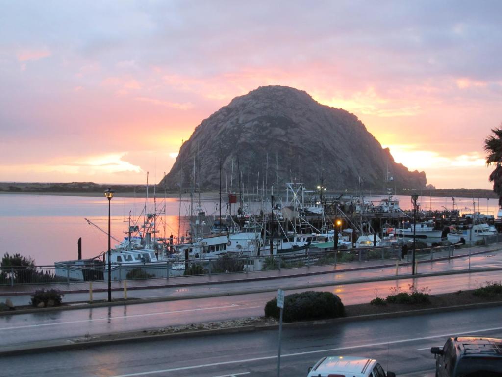 a group of boats docked at a harbor with a mountain at Front Street Inn and Spa in Morro Bay