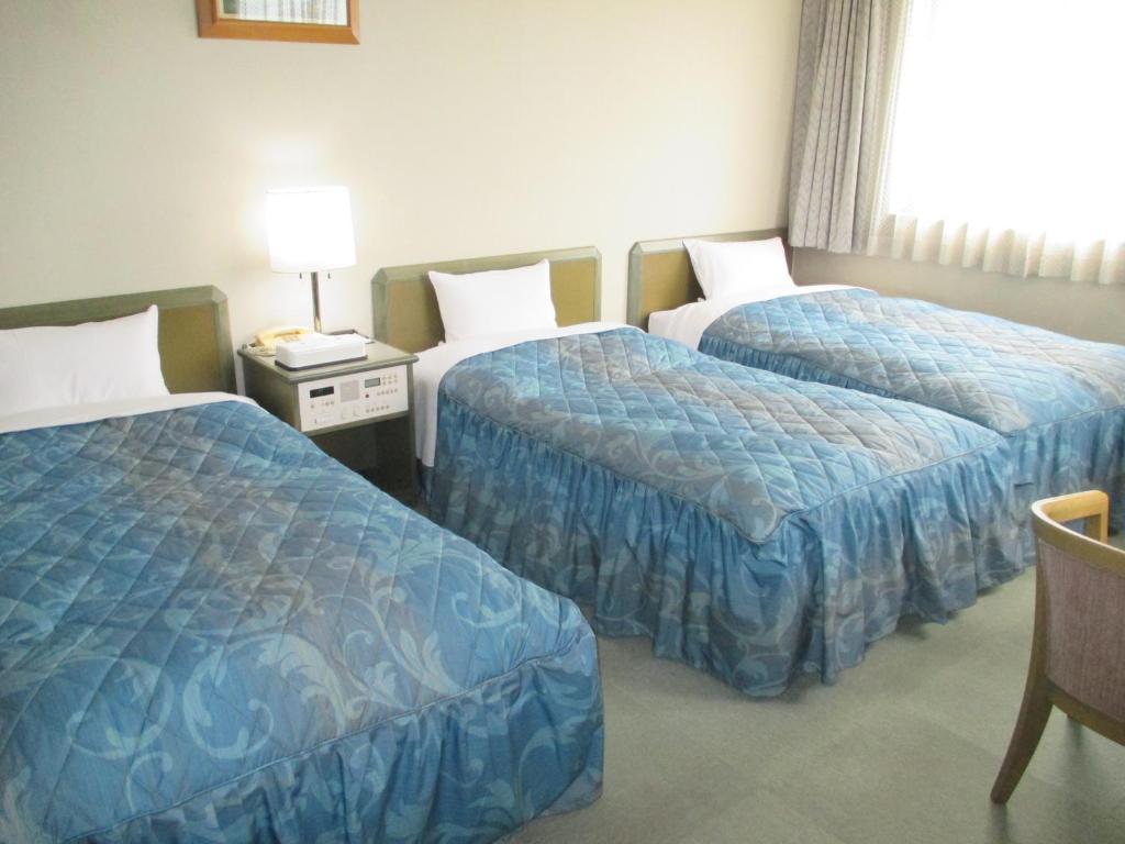 Postel nebo postele na pokoji v ubytování Pulses Inn Kyoto