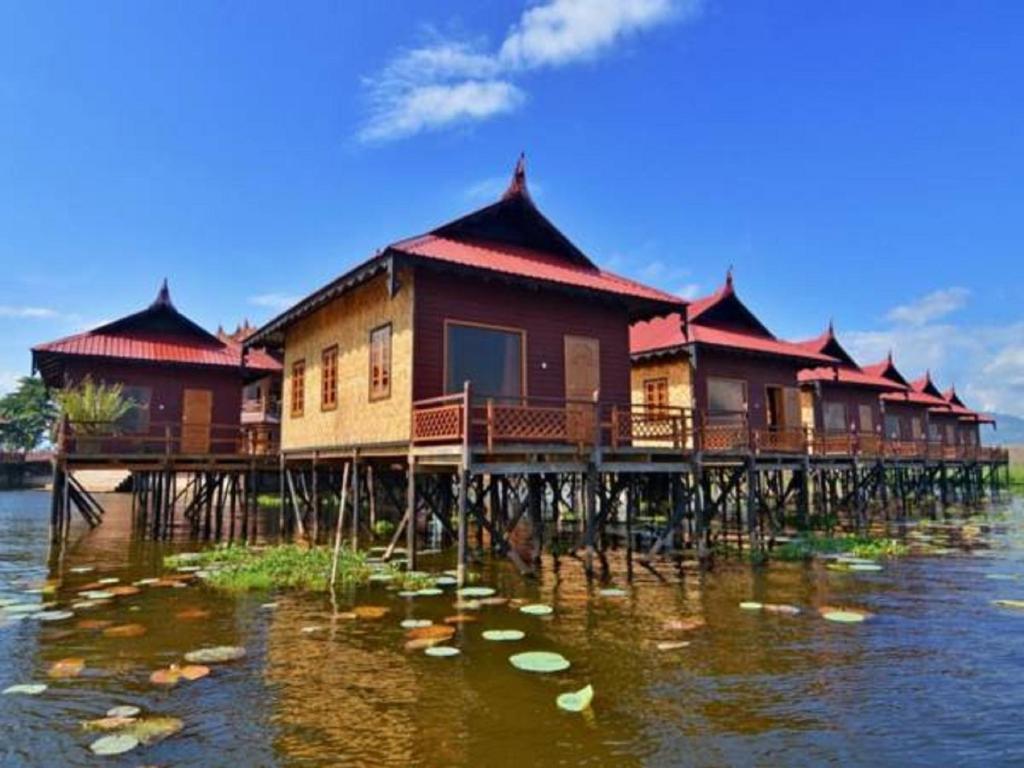 a row of houses on a pier in the water at Ann Heritage Lodge in Ywama