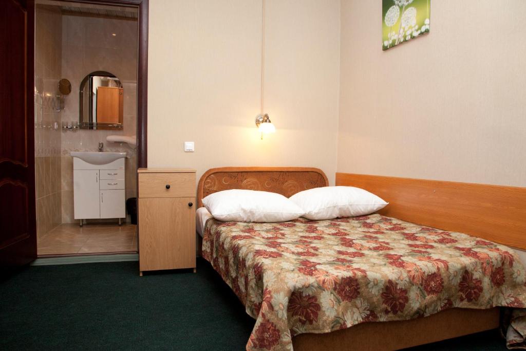 a hotel room with a bed and a bathroom at Chita Hotel in Chita