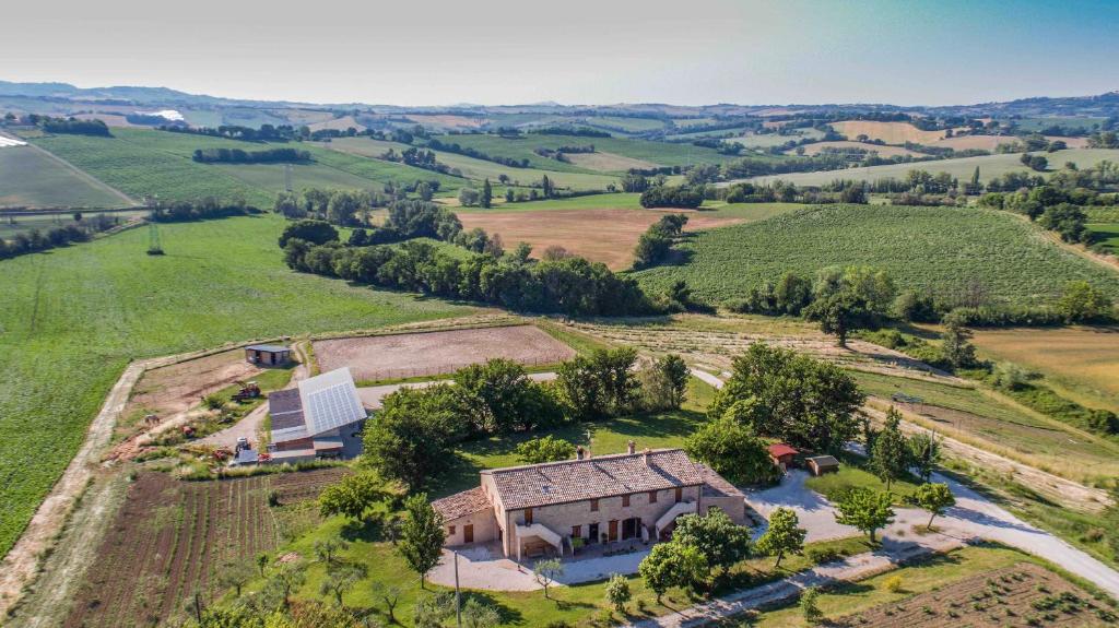 an aerial view of a farmhouse in a field at Casale Talevi in Cartoceto