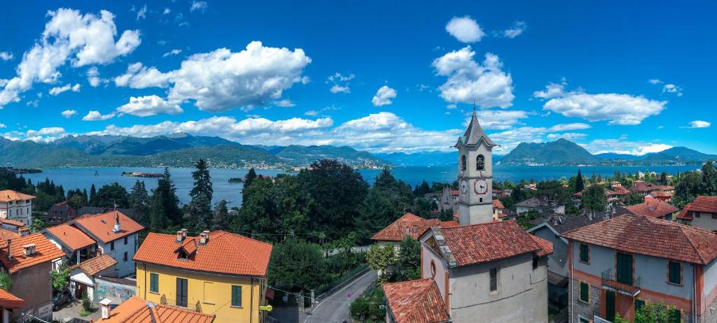 a view of a town with a clock tower at Fruit'n Joy in Stresa