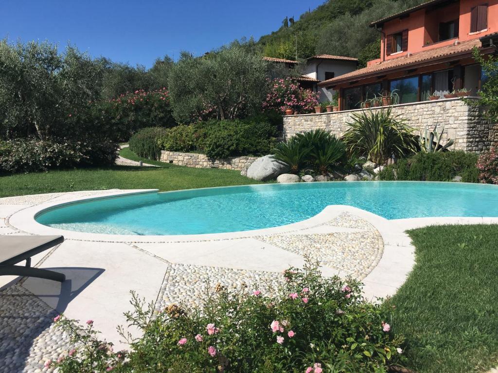 a swimming pool in a yard with a house at Energaia in Toscolano Maderno