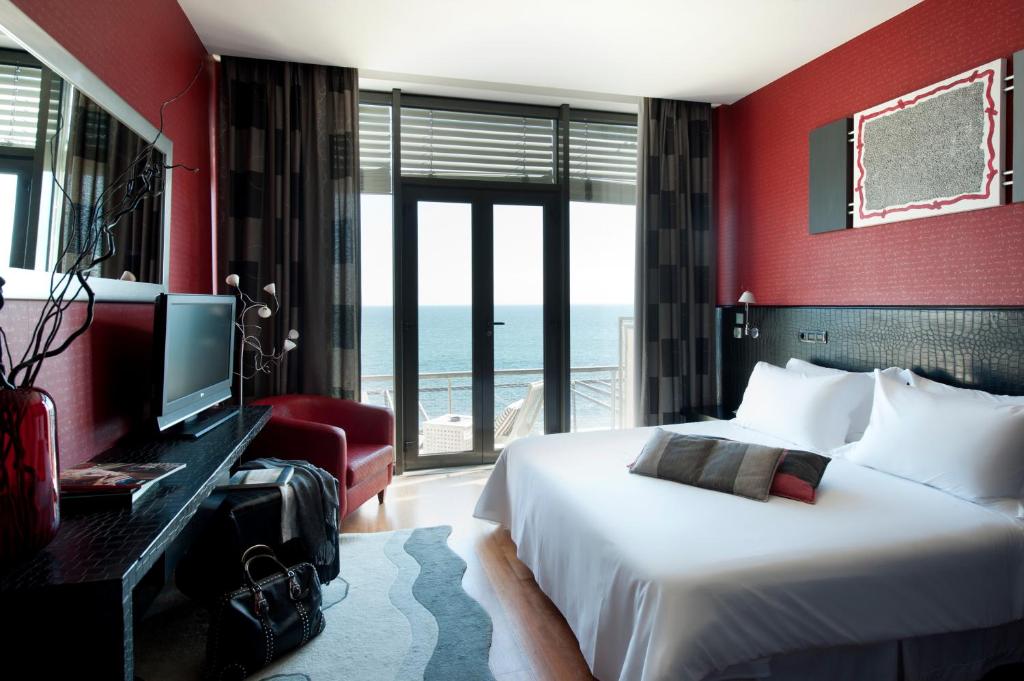 a hotel room with a bed and a television at Farol Hotel in Cascais