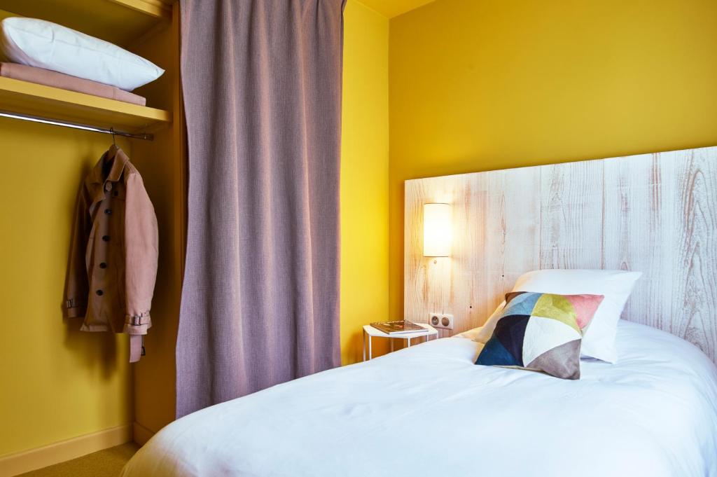 Postel nebo postele na pokoji v ubytování Le Central Boutique Hôtel