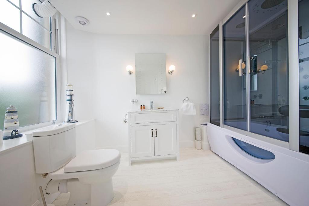 uma casa de banho com um WC, um lavatório e uma banheira em Falls of Lora Hotel em Oban