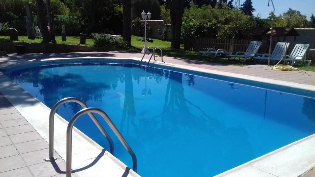 a large swimming pool with blue water at Xanadu Rural in Chiclana de la Frontera