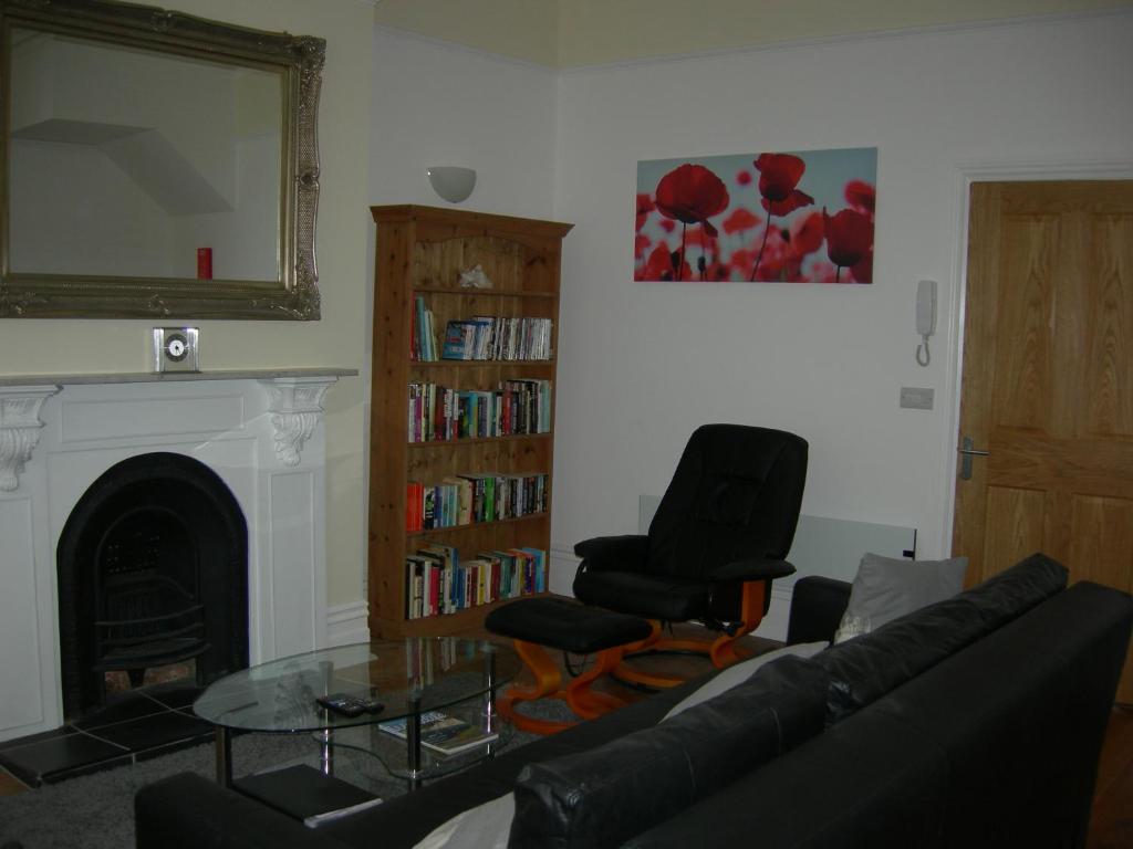 a living room with a couch and a glass table at High Street Suites 3 in Ventnor