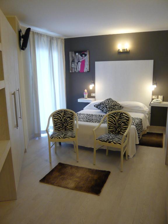 Postel nebo postele na pokoji v ubytování Hotel La Sacca