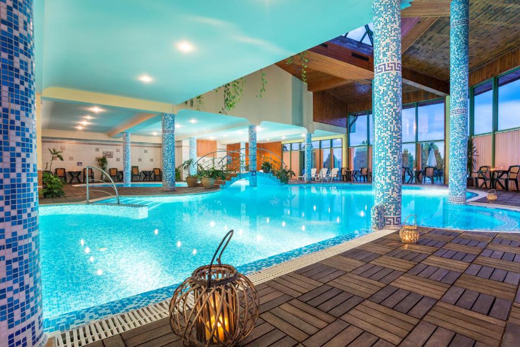 a large swimming pool in a hotel with lights at SPA Hotel Olymp in Velingrad