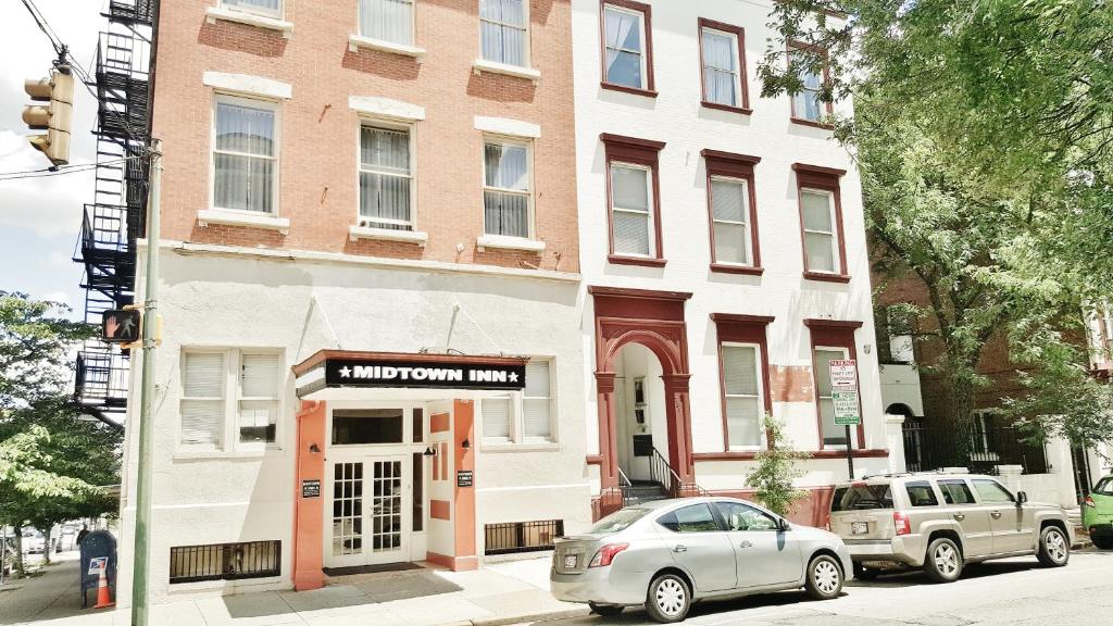 a building on a street with cars parked in front of it at Midtown Inn in Baltimore