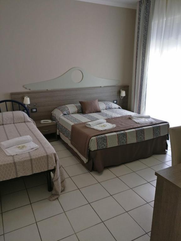 Postel nebo postele na pokoji v ubytování Hotel I Pini