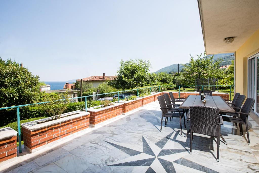 a patio with a table and chairs on a balcony at Apartment Pepi in Lovran