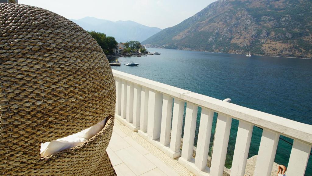 a view of a body of water from a balcony at PENTHOUSE STOLIV Villa located 5 meters from the sea SPA-Pool Exclusive Terrace,Private Jetty Sunbeds, Pebble Beach, Secluded location Total area 375m2 at your disposal in Kotor